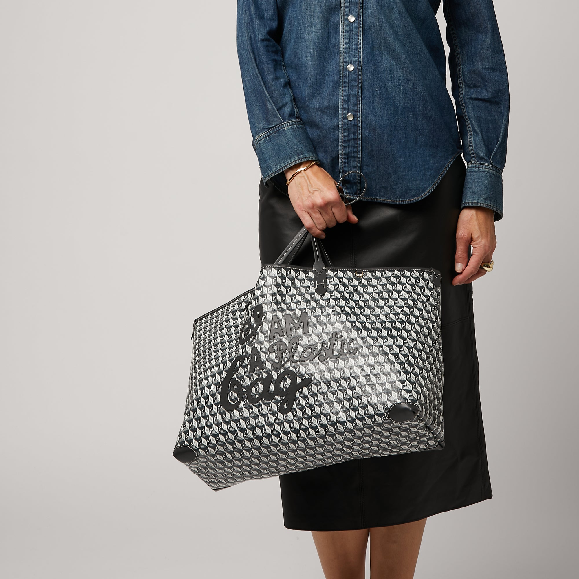 I Am A Plastic Bag Motif Tote -

                  
                    Recycled Coated Canvas in Charcoal -
                  

                  Anya Hindmarch US
