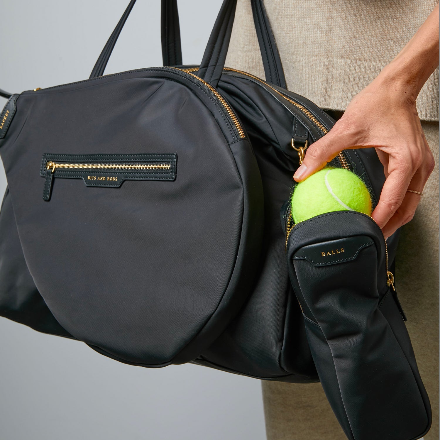 Tennis Bag -

                  
                    Econyl® Regenerated Nylon in Black -
                  

                  Anya Hindmarch US
