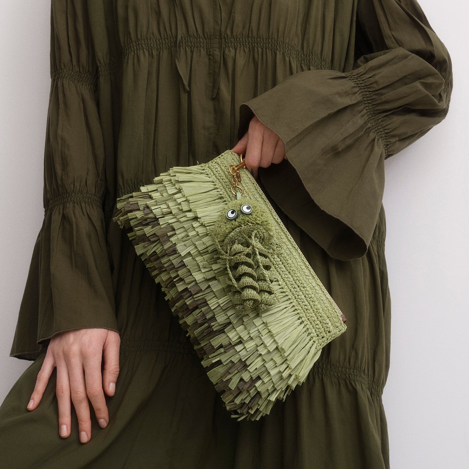 Green jellyfish charm made of raffia by Anya Hindmarch