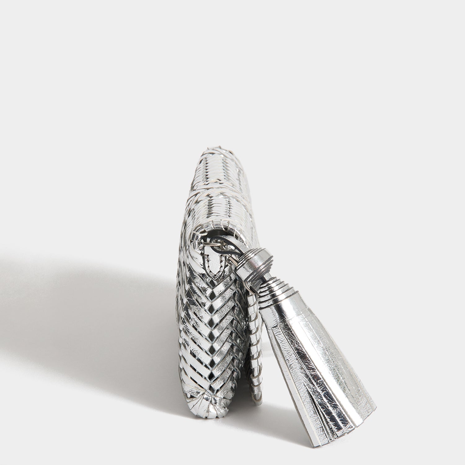 Neeson Tassel Clutch -

          
            Capra Leather in Silver -
          

          Anya Hindmarch US
