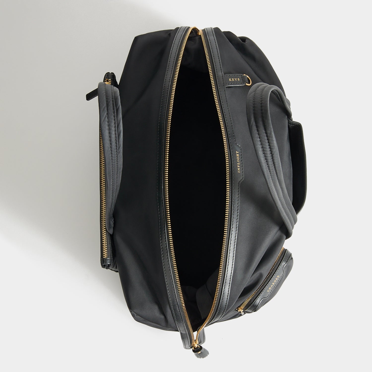 In-Flight Travel Bag -

          
            Regenerated Econyl® in Black -
          

          Anya Hindmarch US
