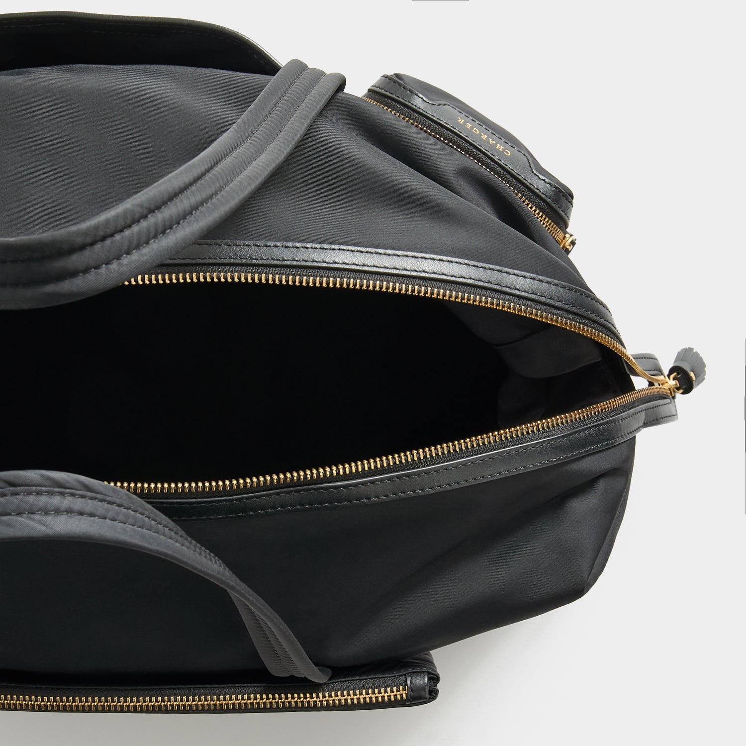 In-Flight Travel Bag -

          
            Regenerated Econyl® in Black -
          

          Anya Hindmarch US
