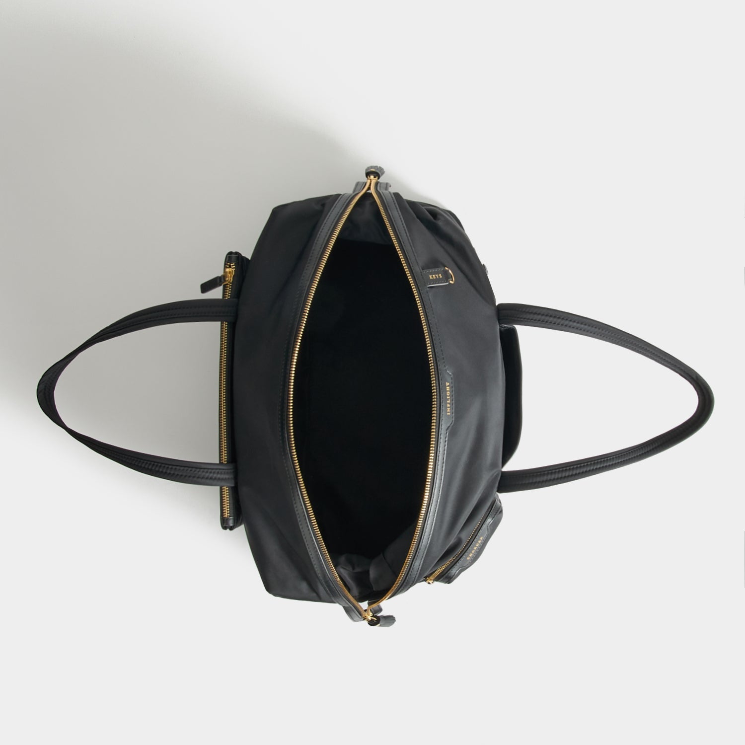 In-Flight Travel Bag -

          
            Regenerated Econyl® in Black -
          

          Anya Hindmarch US
