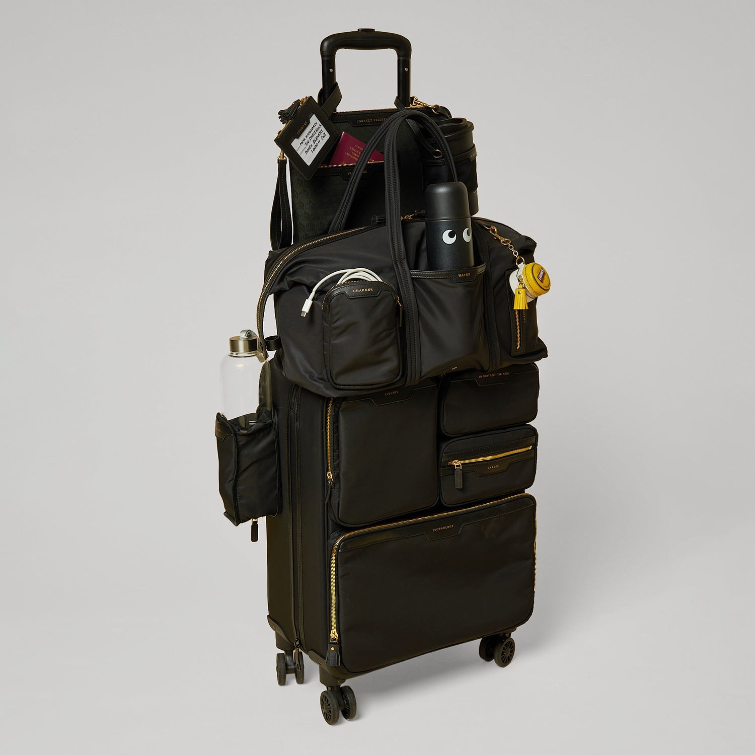 Short-Haul Suitcase -

          
            Econyl® Regenerated Nylon in Black -
          

          Anya Hindmarch US
