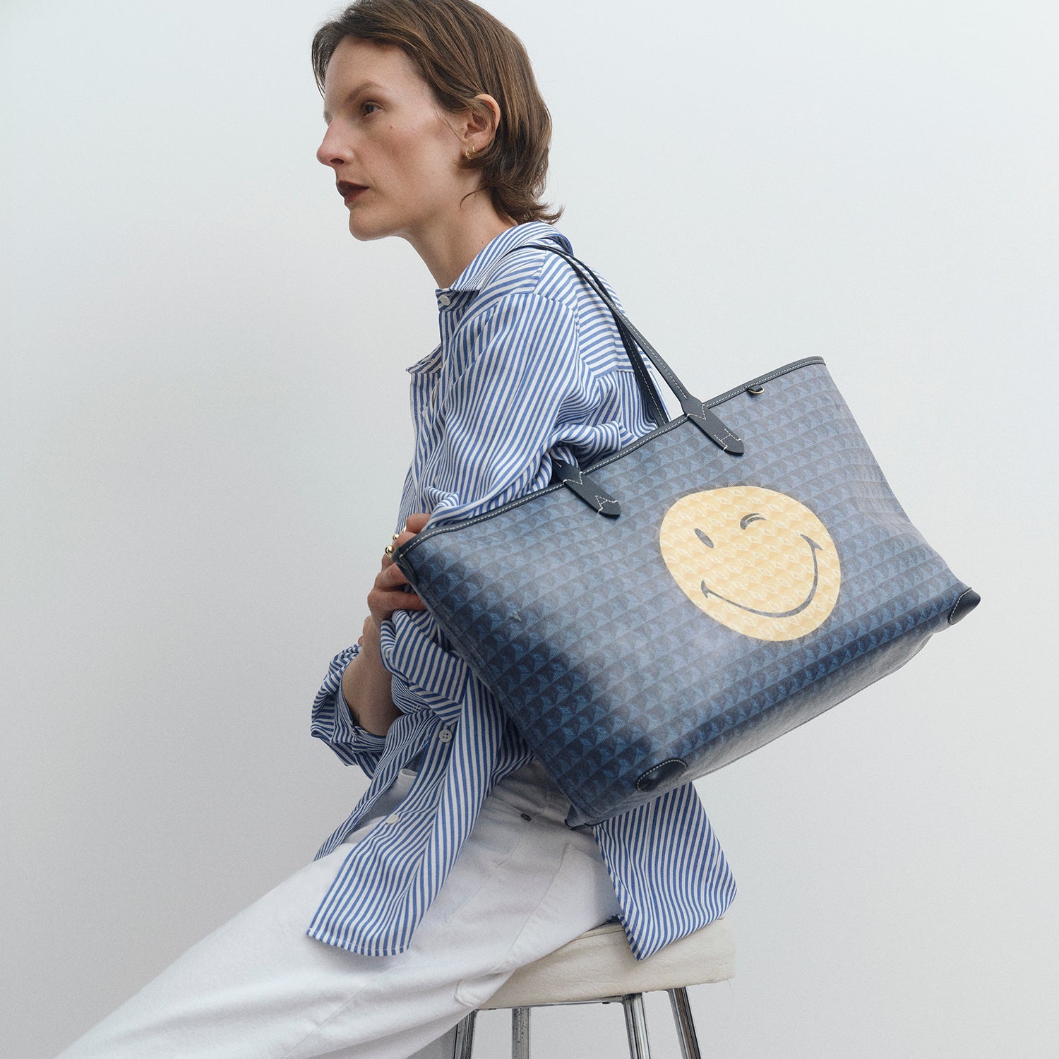 I am a Plastic Bag Wink Zipped Tote -

          
            Recycled Canvas in Marine -
          

          Anya Hindmarch US
