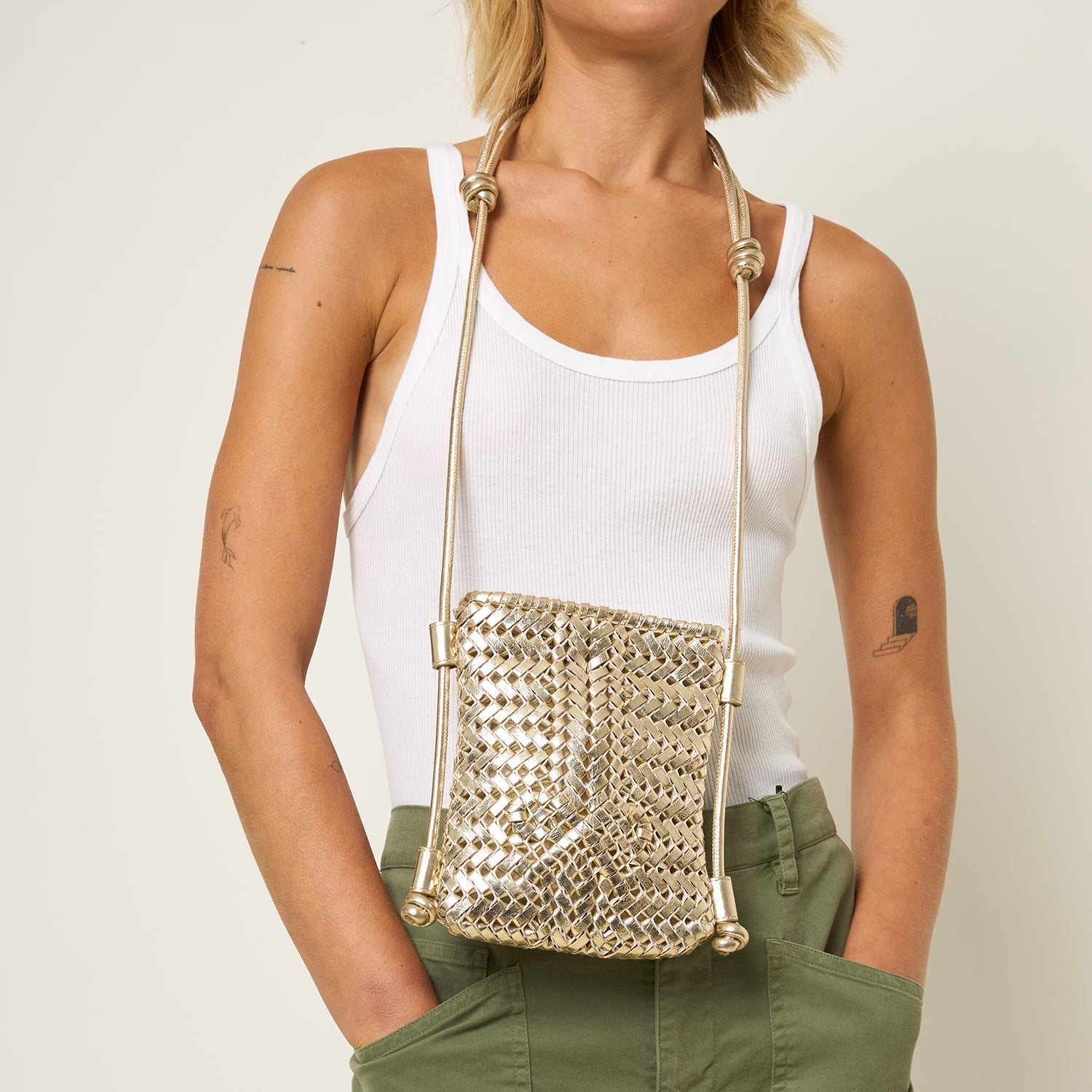 Neeson Cross-body Pouch -

          
            Capra Leather in Platino Gold -
          

          Anya Hindmarch US

