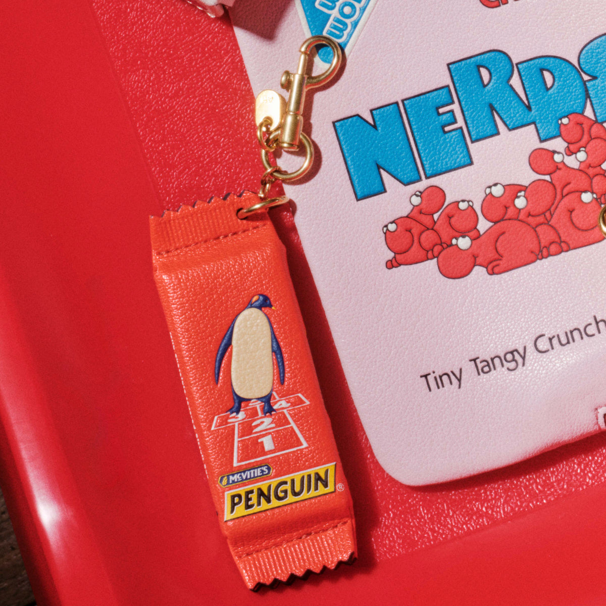 Anya Brands McVitie's Penguin Charm -

          
            Calf Leather in Flag Red -
          

          Anya Hindmarch US
