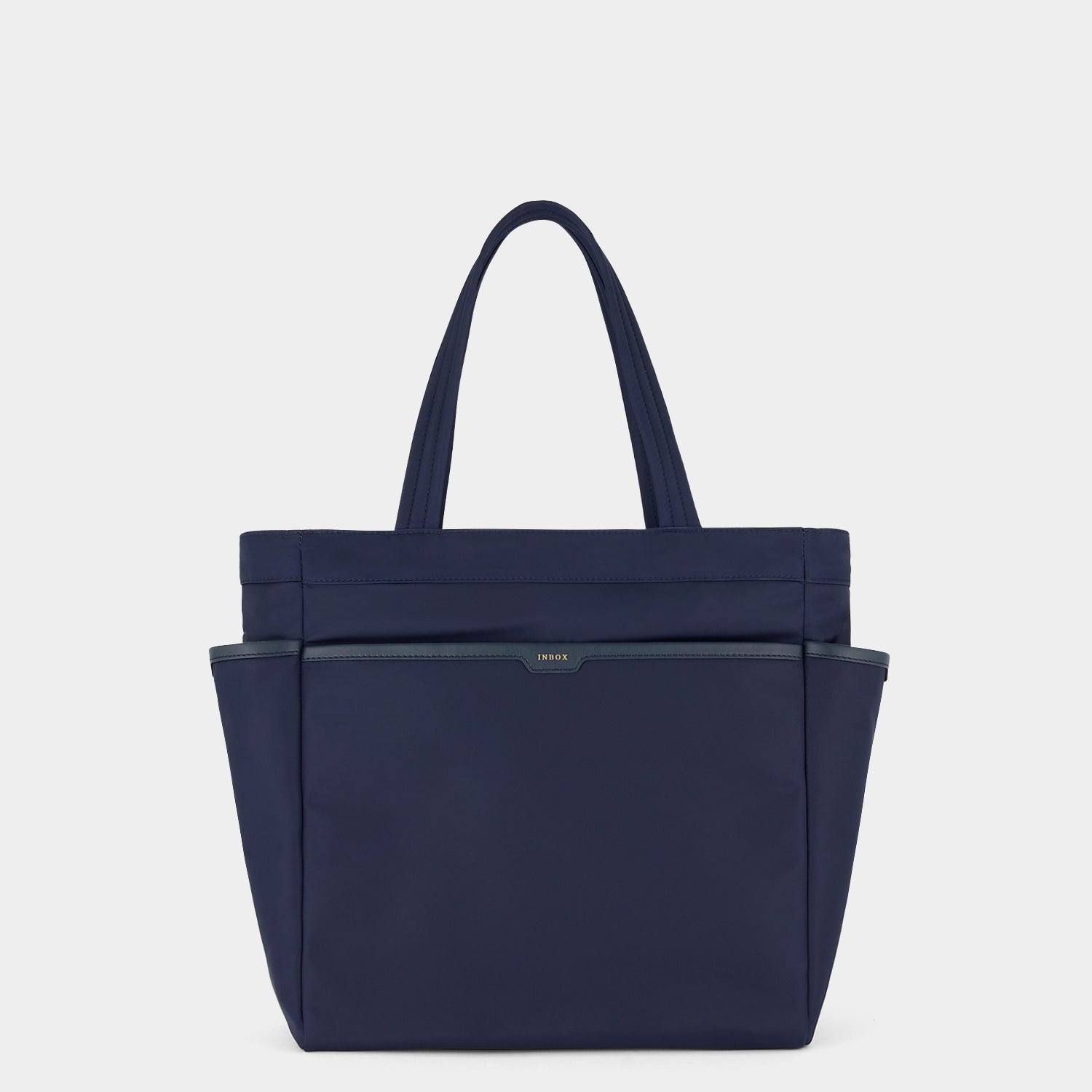 Commuter Tote -

          
            Regenerated Econyl® in Marine -
          

          Anya Hindmarch US
