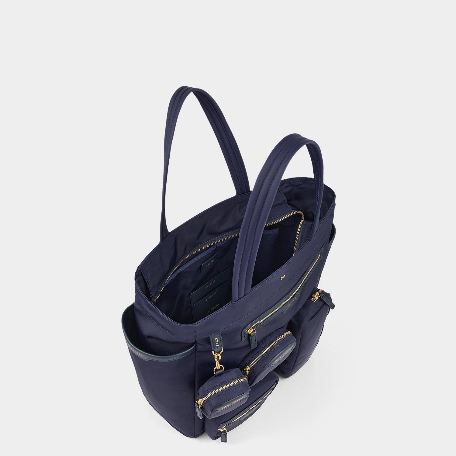 Commuter Tote -

          
            Regenerated Econyl® in Marine -
          

          Anya Hindmarch US
