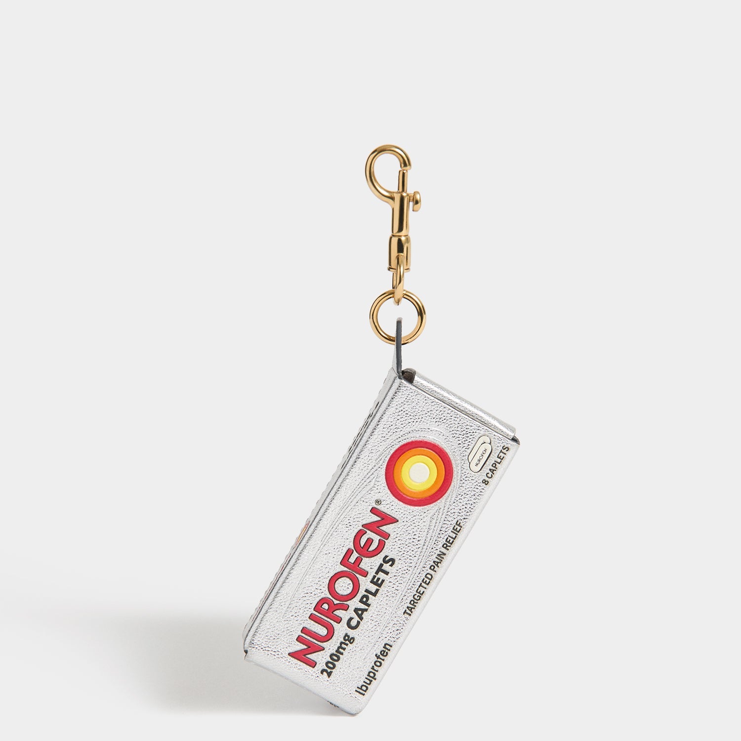 Anya Brands Nurofen Charm -

          
            Capra Leather in Metallic Silver -
          

          Anya Hindmarch US
