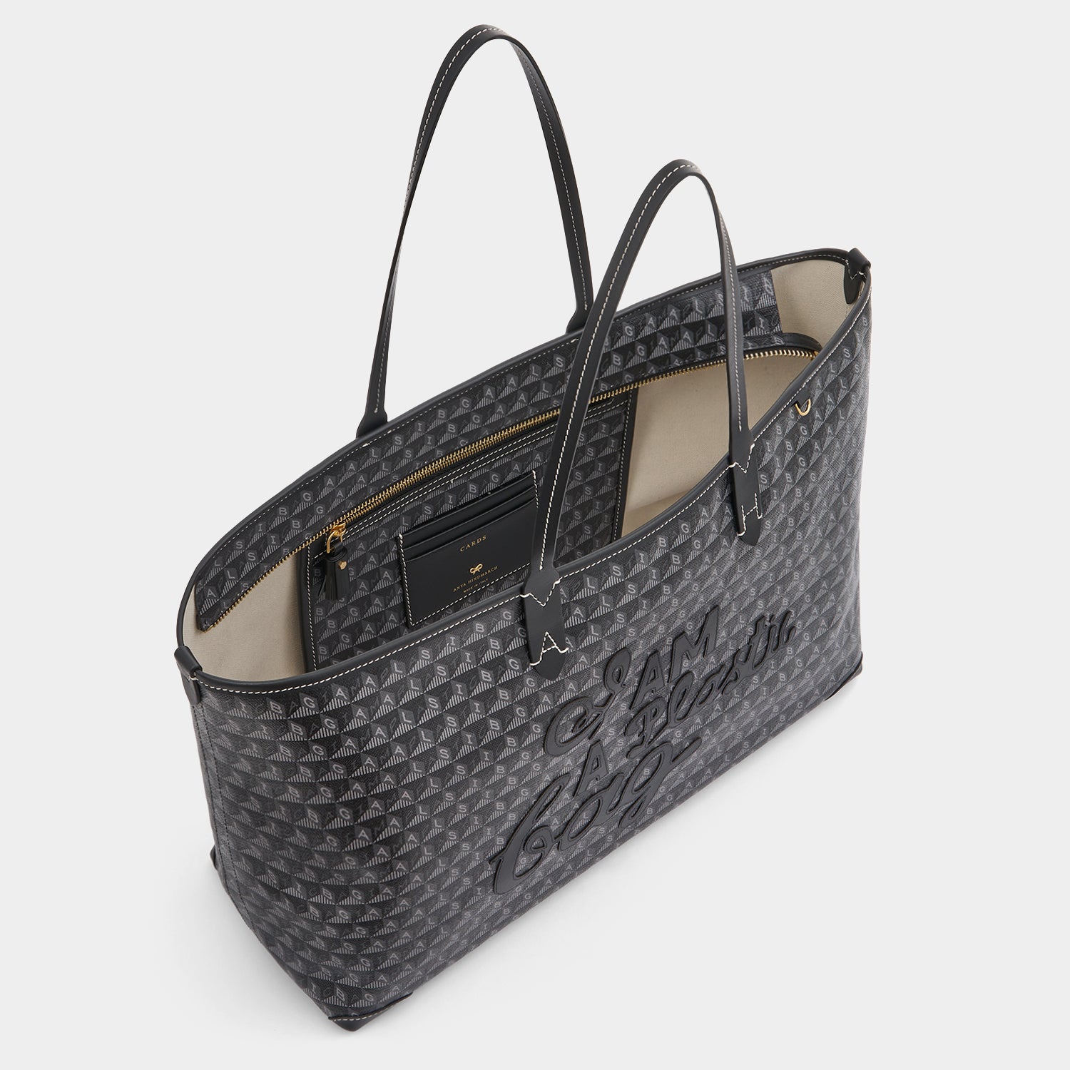 I Am A Plastic Bag Zipped Motif Tote -

          
            Recycled Canvas in Black -
          

          Anya Hindmarch US
