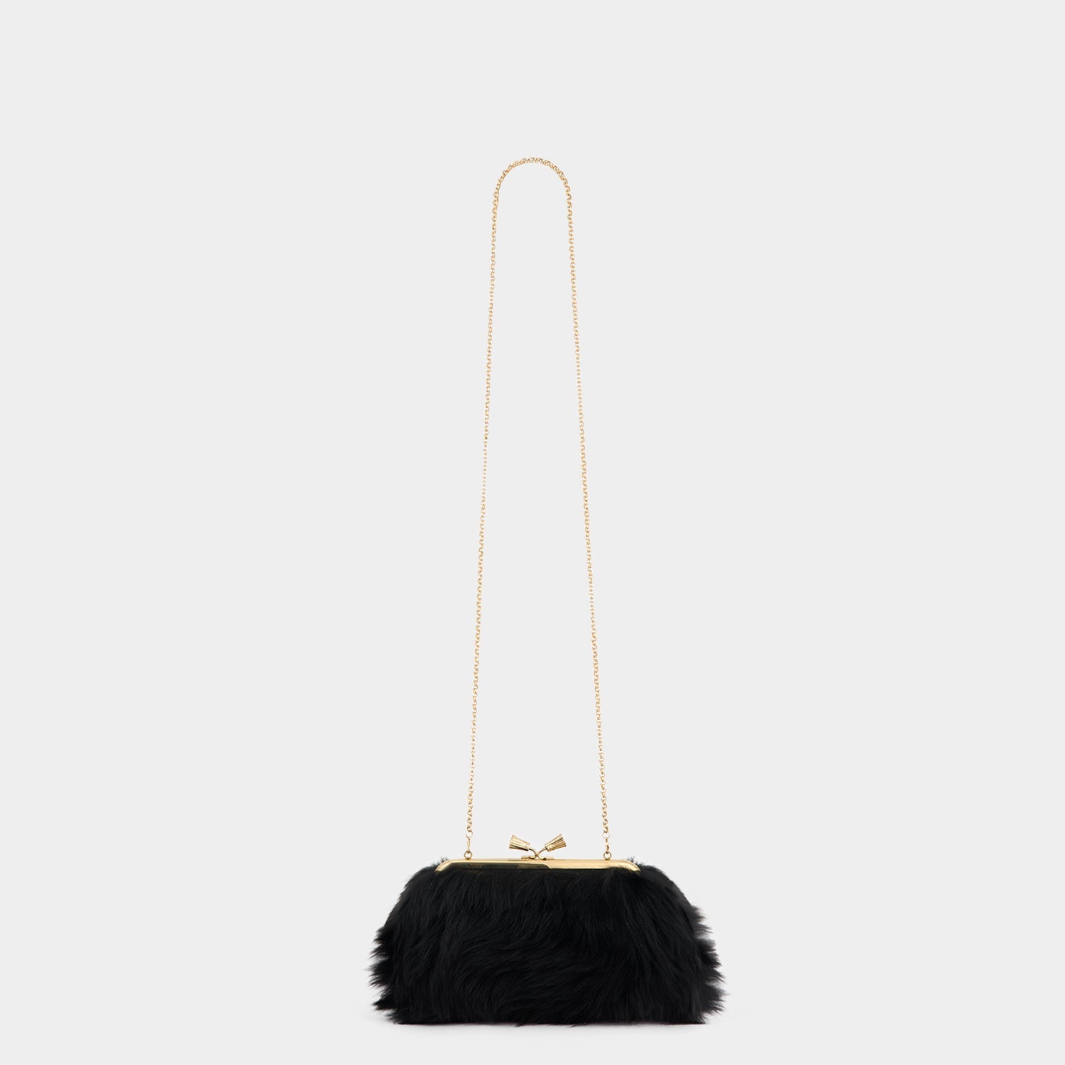 Maud Shearling Tassel Clutch -

          
            Shearling in Black -
          

          Anya Hindmarch US
