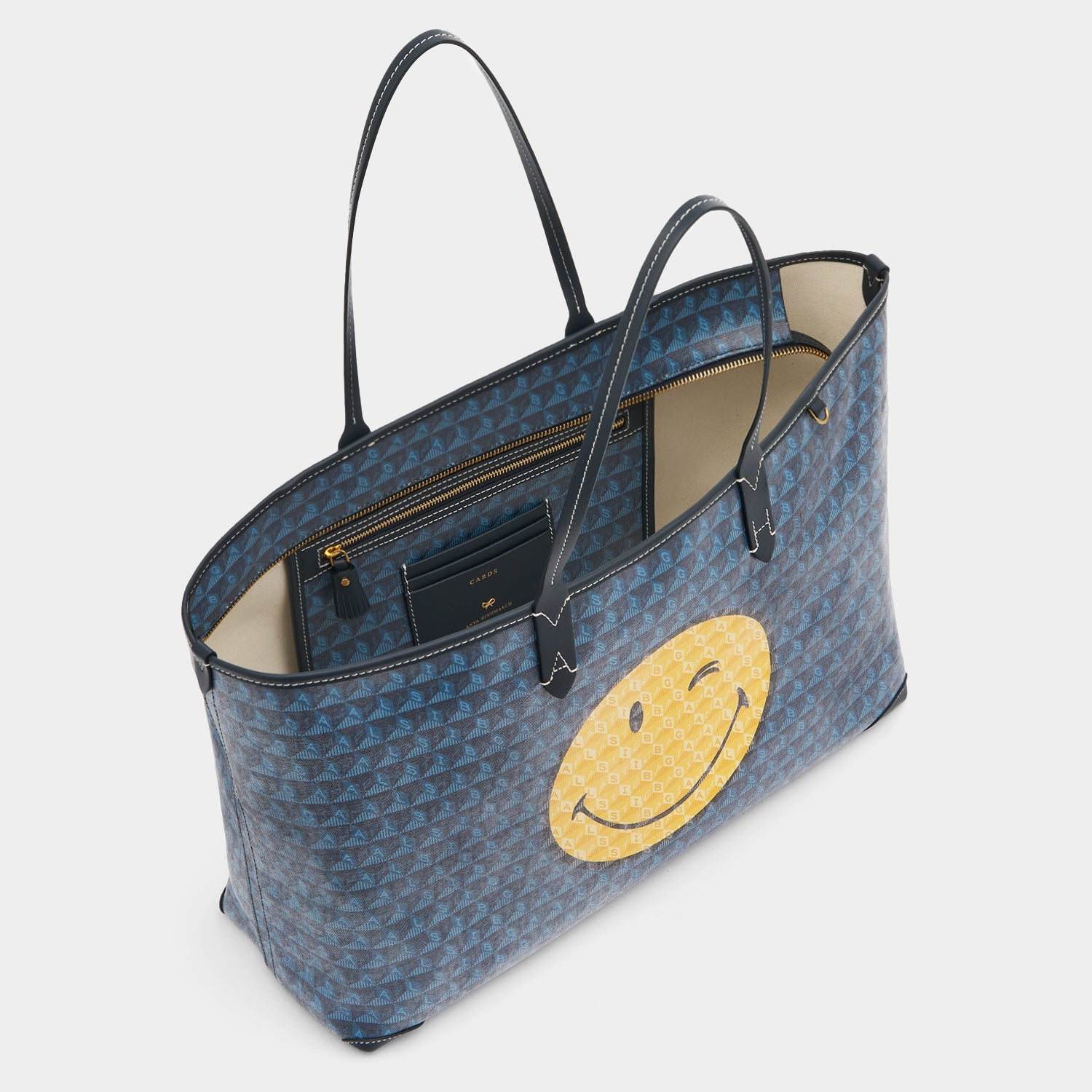 I am a Plastic Bag Wink Zipped Tote -

          
            Recycled Canvas in Marine -
          

          Anya Hindmarch US
