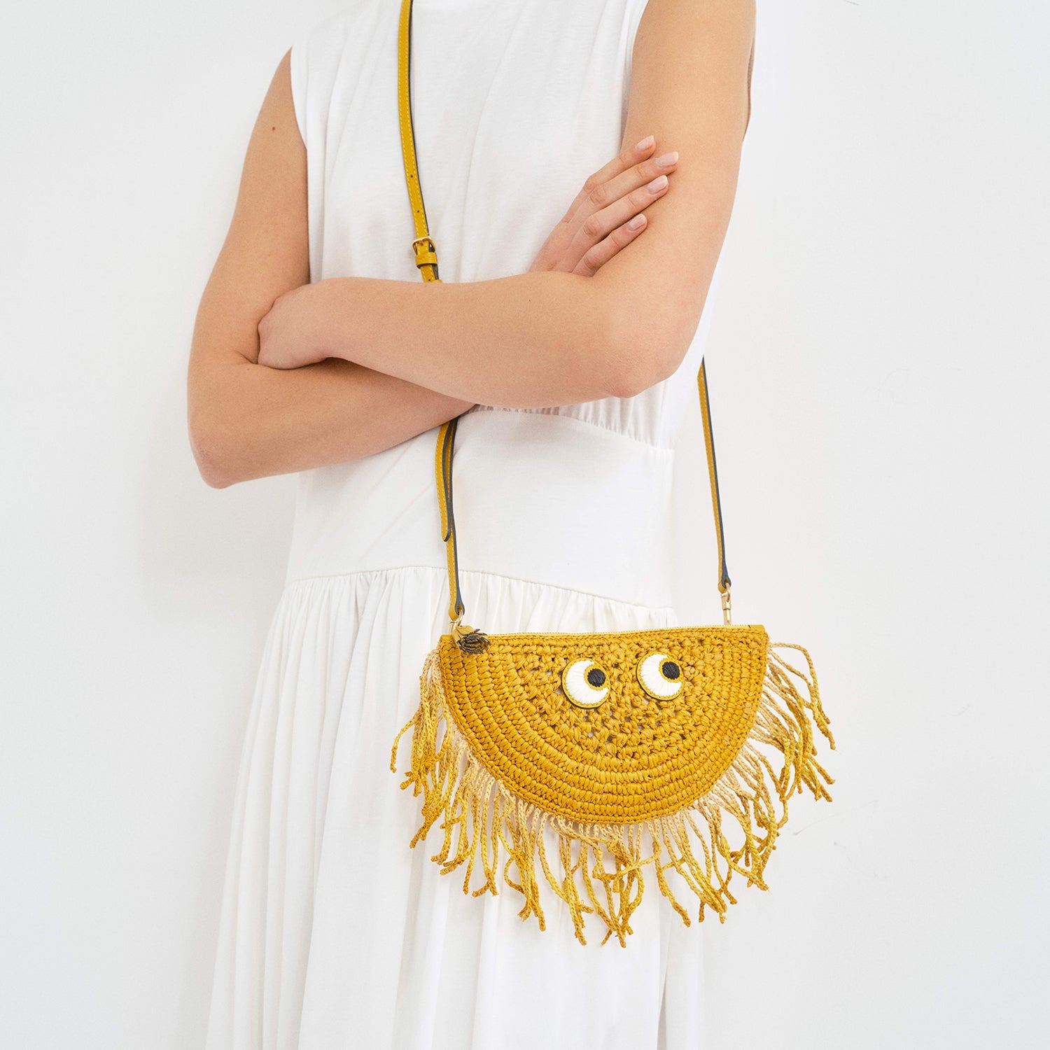 handwoven cross body raffia bag shaped like a half sun by anya 