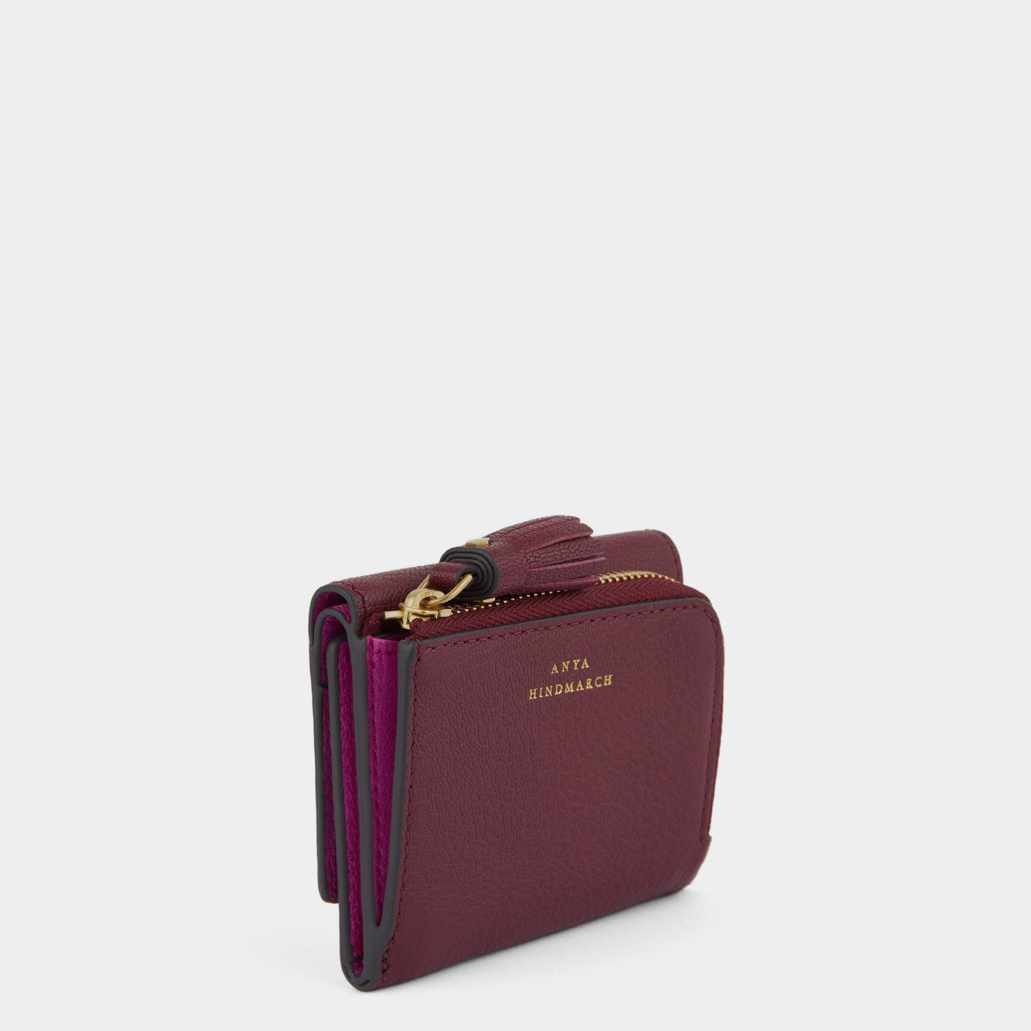 Purple leather trifold wallet by Anya Hindmarch