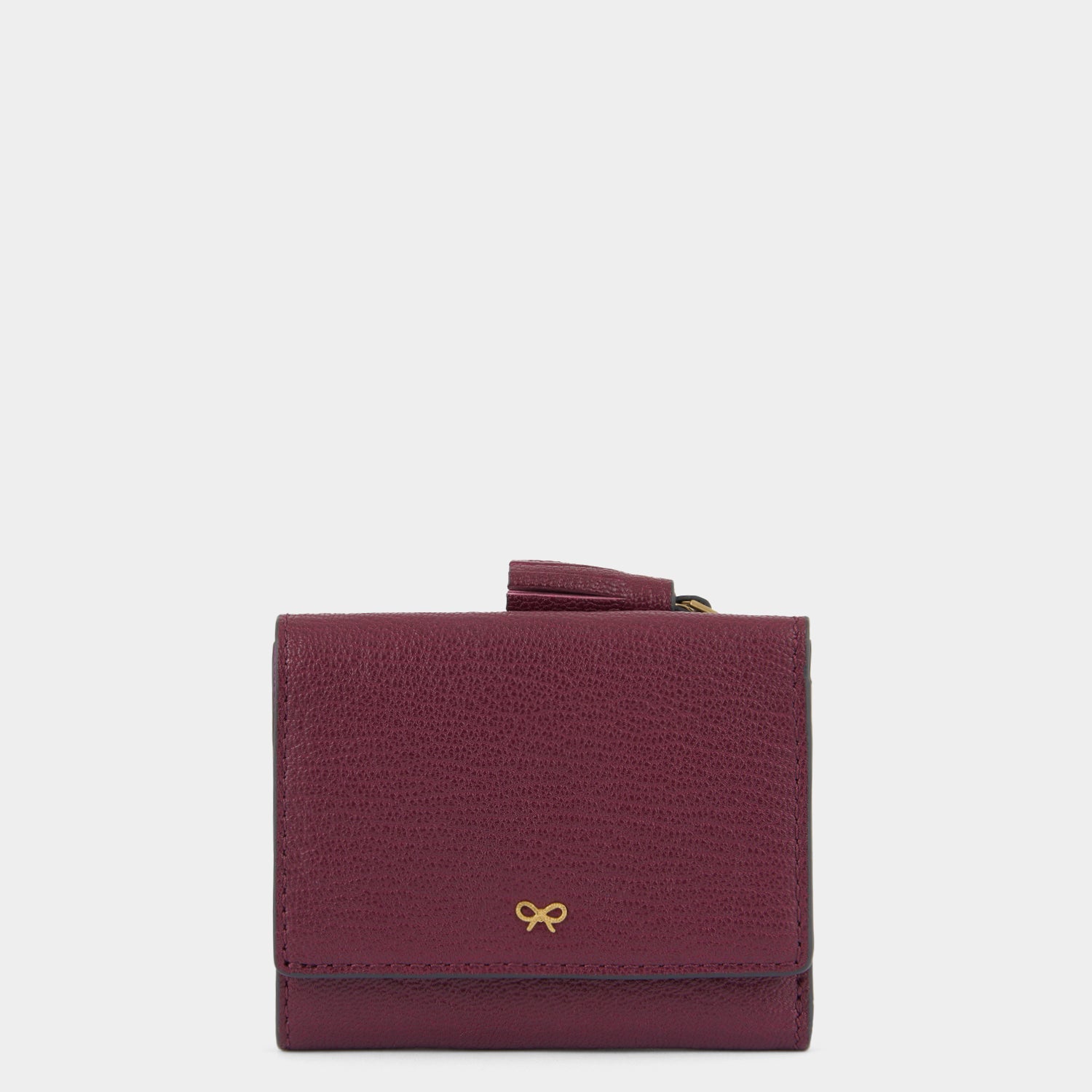 Purple leather trifold wallet by Anya Hindmarch