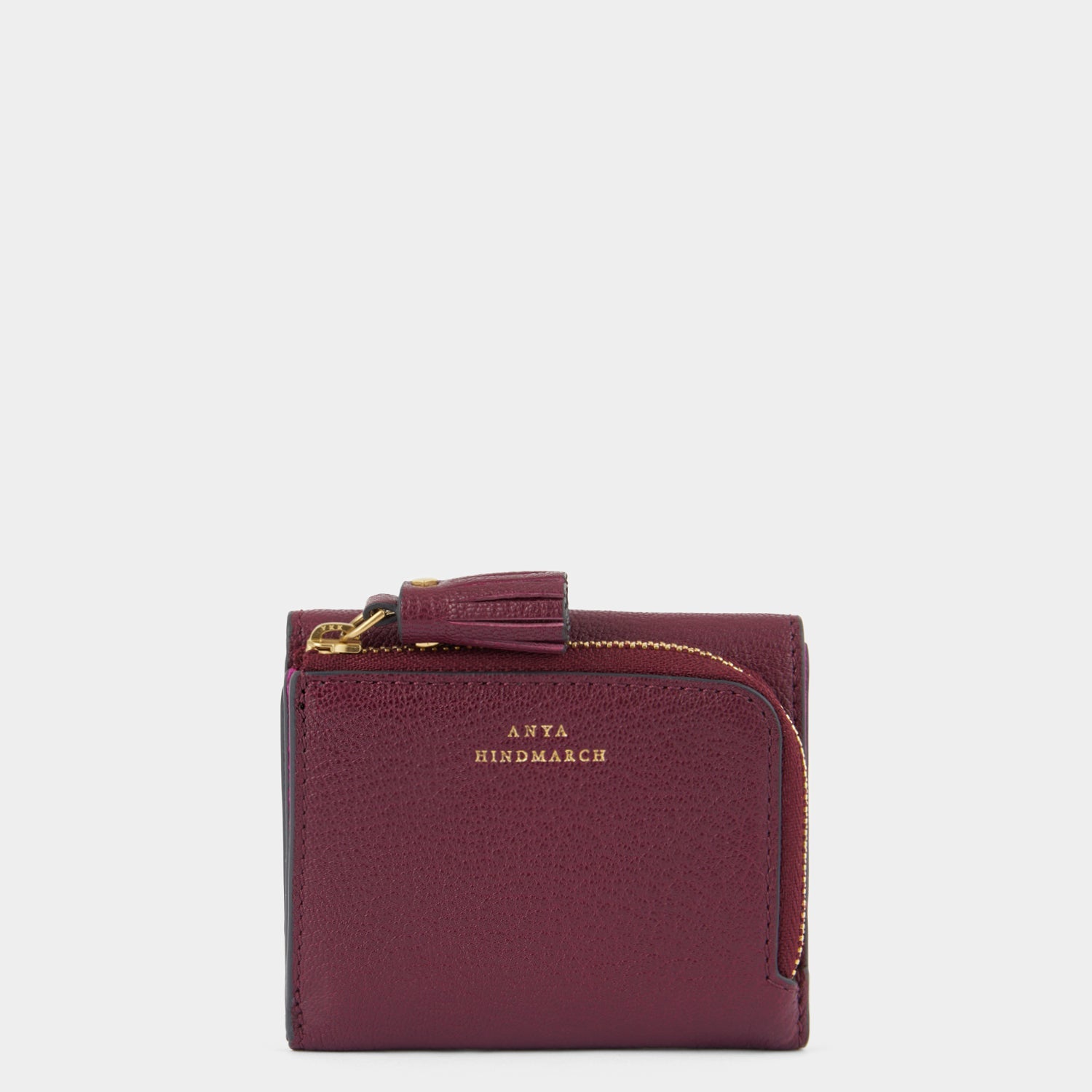 Purple leather trifold wallet by Anya Hindmarch
