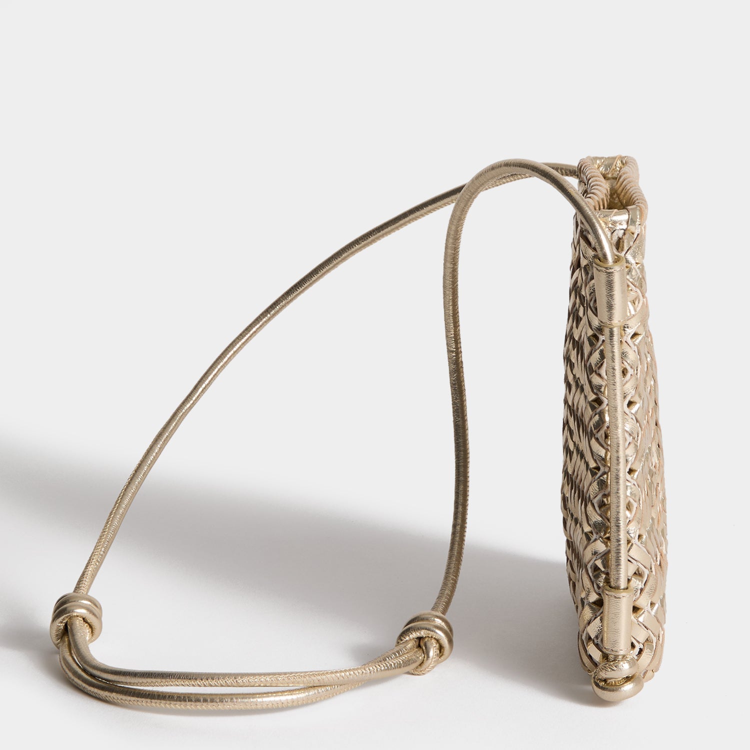 Neeson Cross-body Pouch -

          
            Capra Leather in Platino Gold -
          

          Anya Hindmarch US

