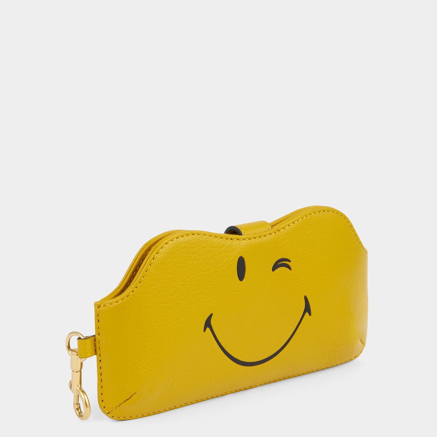 Yellow leather sunglasses holder with winky face by Anya Hindmarch