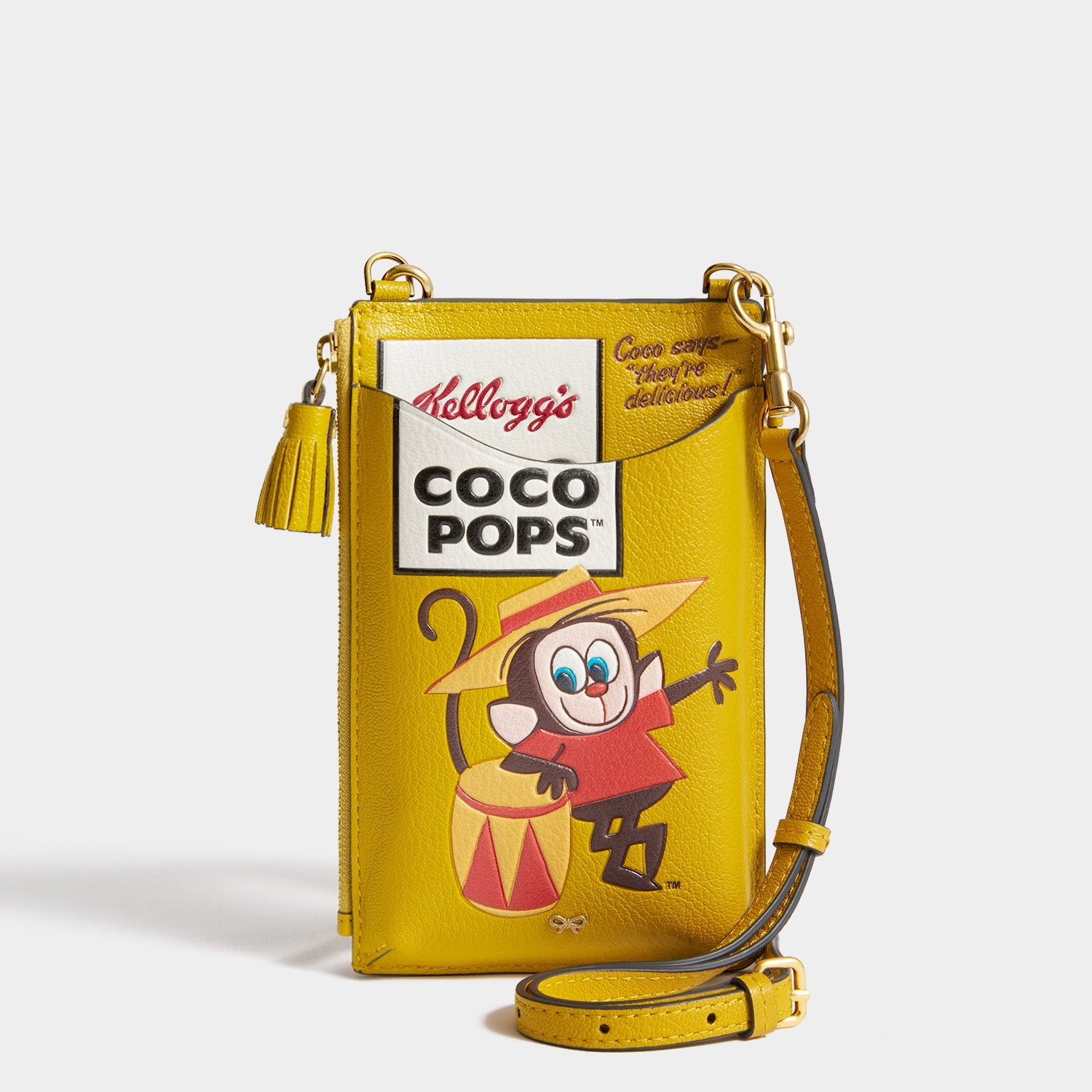 Anya Brands Coco Pops Zip Phone Pouch -

          
            Shiny Capra Leather in Mustard -
          

          Anya Hindmarch US

