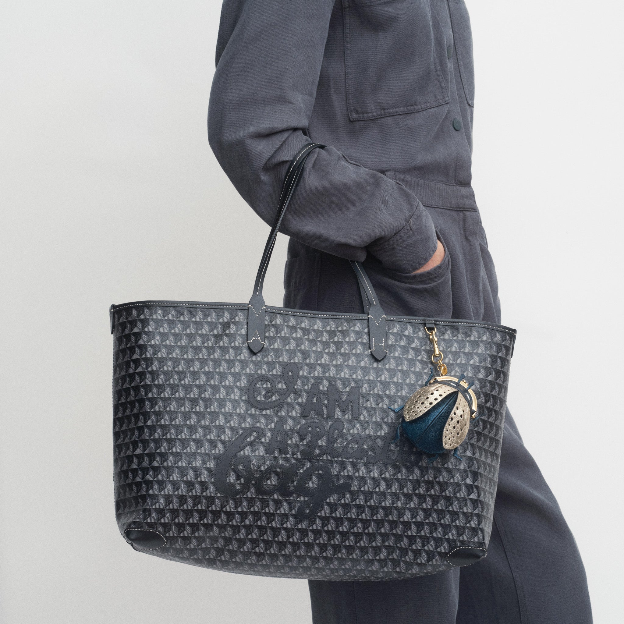 I Am A Plastic Bag Zipped Motif Tote -

          
            Recycled Canvas in Black -
          

          Anya Hindmarch US
