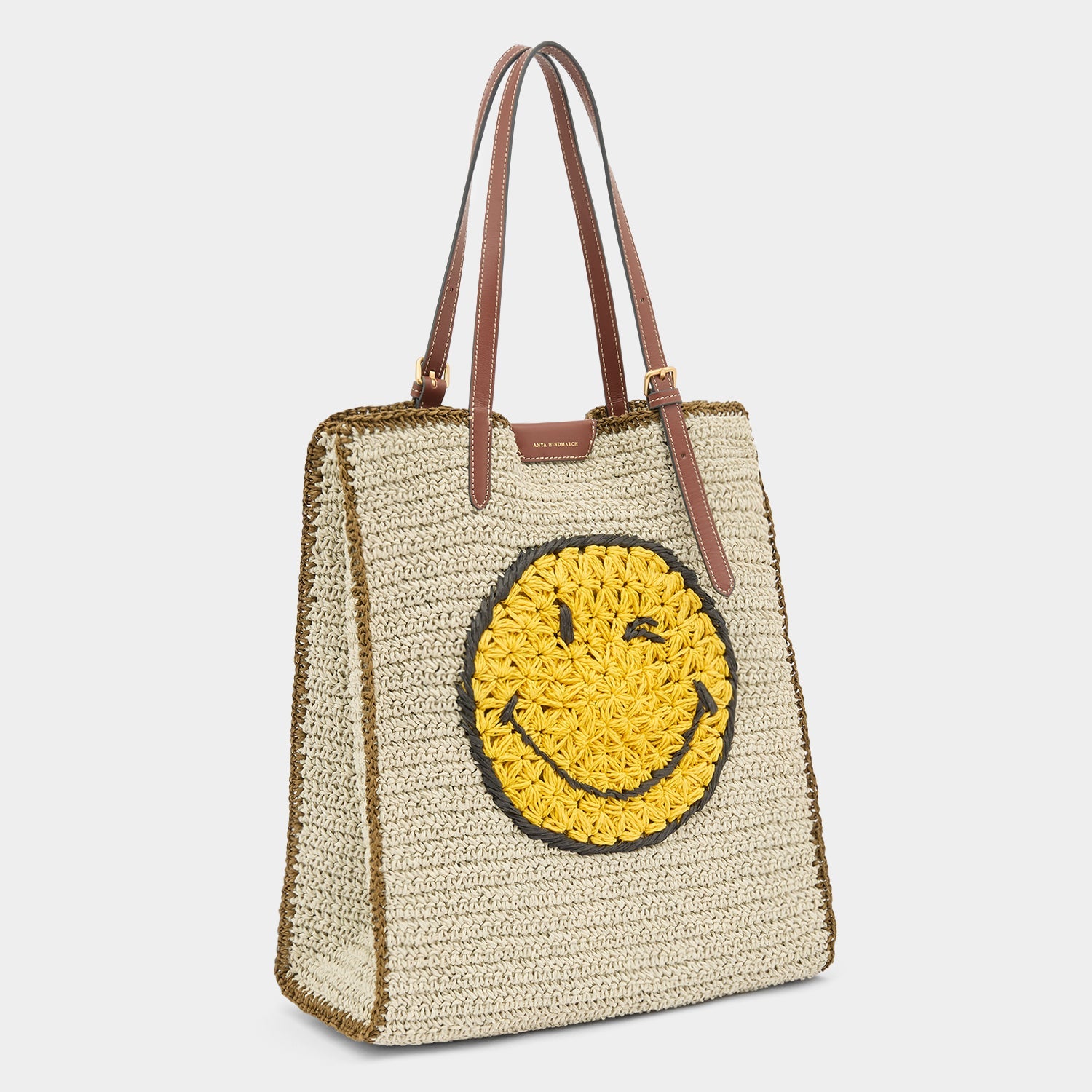Per raffia tote with winky emojy face by Anya Hindmarch