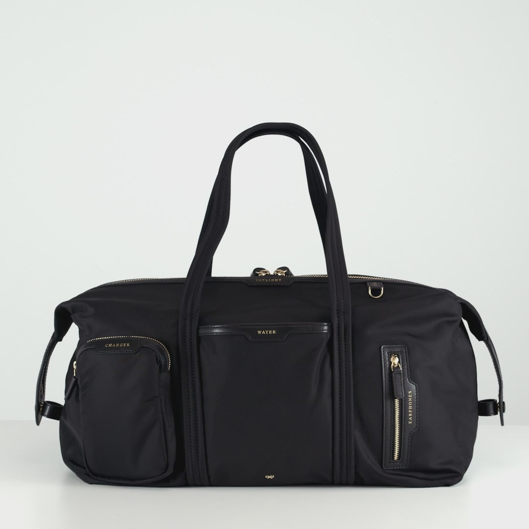 In-Flight Travel Bag -

          
            Regenerated Econyl® in Black -
          

          Anya Hindmarch US
